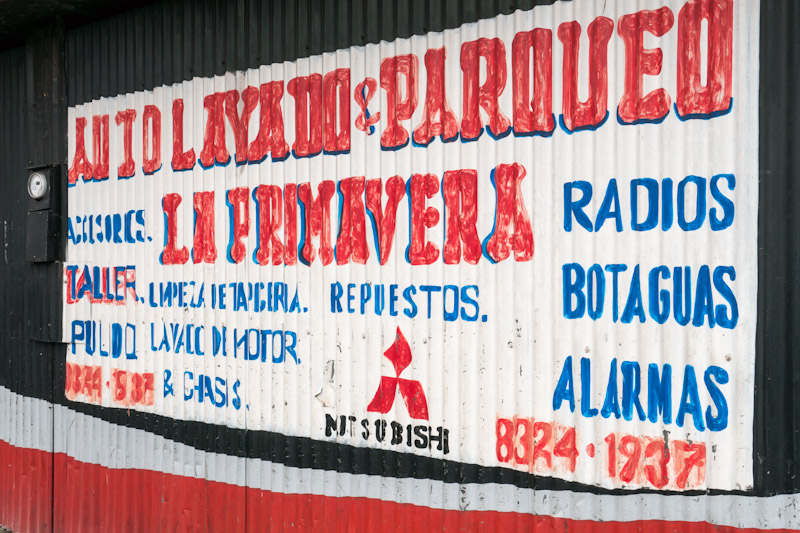 Hand painted advertisement on corrugated iron