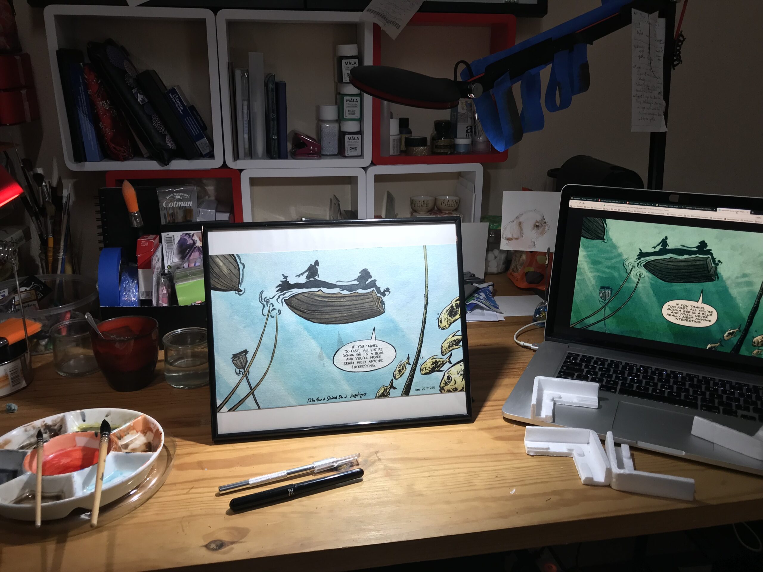 Photo of the framed painting on my desk between the palette and the computer displaying the reference picture.