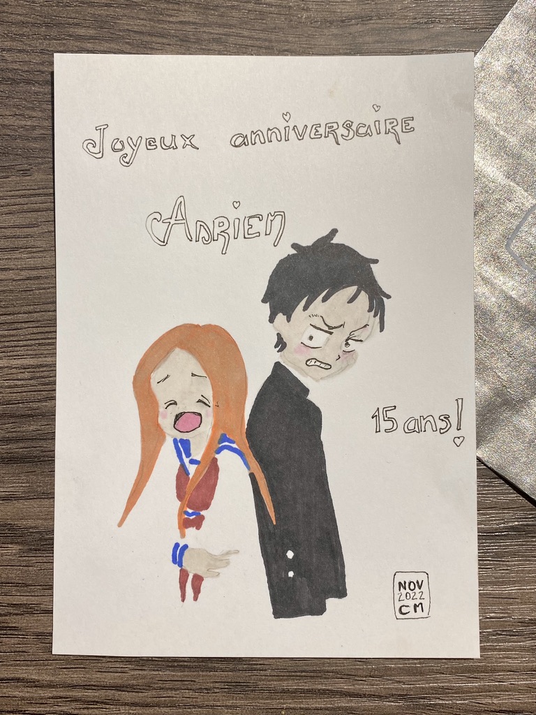 Hand-drawn card of two manga characters back to back: a girl with long orange hair laughing out loud and a tall angry looking boy. I've written 'joyeux anniversaire Adrien' and '15 ans!' on it, dated and signed it.