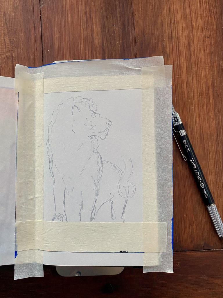 Masking tape applied to the artbook and pencil sketch of a lion
