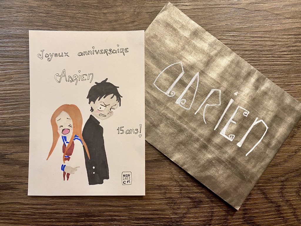 The card next to the envelope I painted in gold ink on which I wrote in huge white letters "Adrien"