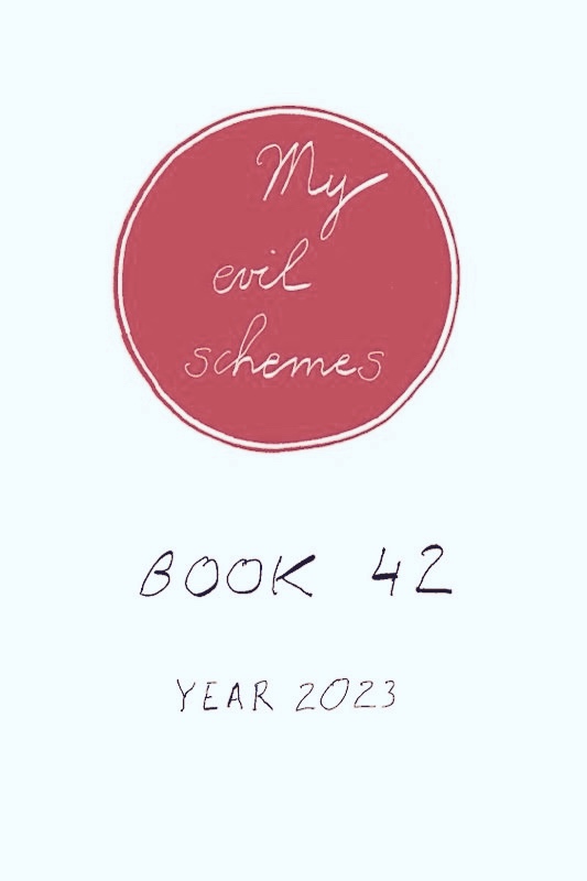 Large red circle and red outer outline within which is hand-written in white: My evil schemes, and in block black letters underneath: Book 42, year 2023