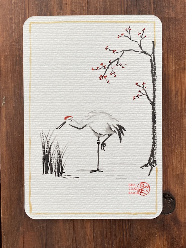 Black ink brushpen and a few touches of geranium red ink for this Japanese crane between a tree with a few red blossoms and some tall blades of grass. There is a golden outline near the edges of the card which I painted with a thin brush and liquid gold ink. The bottom right has my signature: a red upside down (by mistake) Japanese kanji meaning roughly “comes from near the sea”, my nickname and the date.