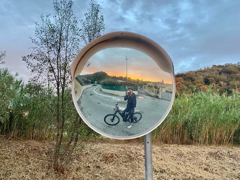 Photo of me reflected in a fish-eye mirror at sunset.