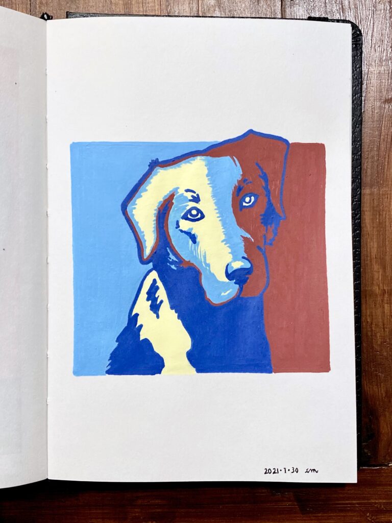 Open artbook on a table with drawing of a dog in bright blues, yellow and red