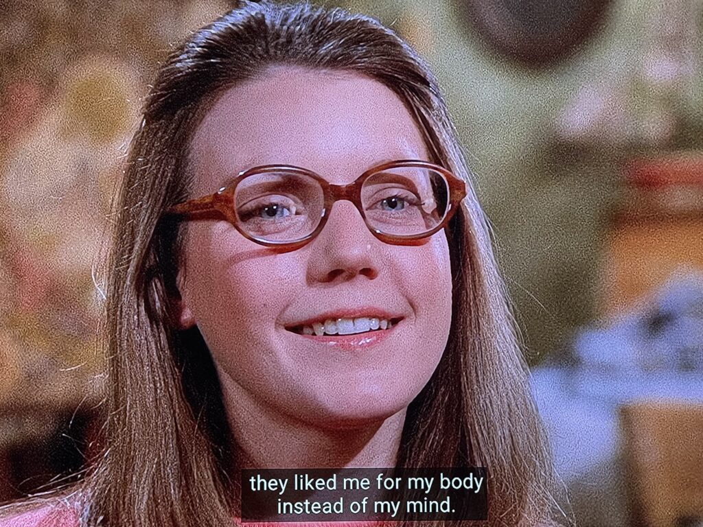 A smiling young woman with eyeglasses looking happy. She said “[it’s the first time someone told me] they liked me for my body instead of my mind.”