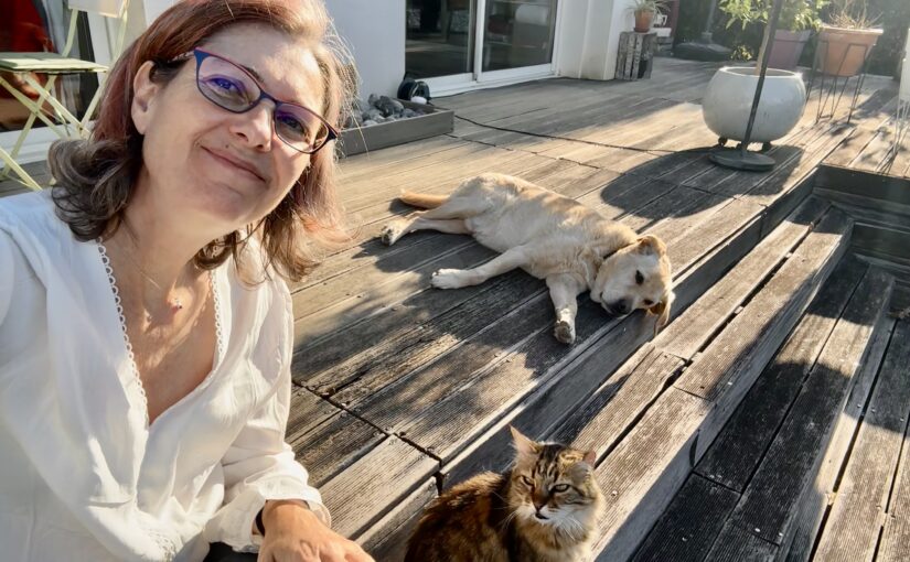 Selfie with the fluffy tabby cat and the yellow Labrador as we hang out on the wooden deck in the sun.
